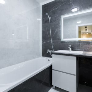 bathroom with black tile interior in a small apartment