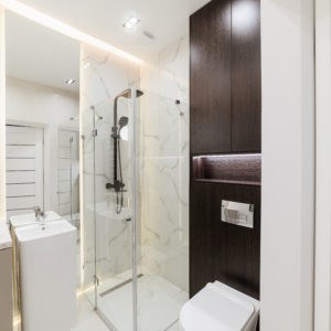 bright bathroom interior with glass shower mirror and lighting