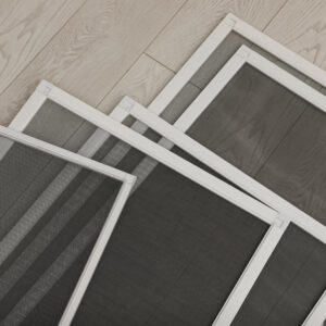 Set of window screens on wooden floor, closeup